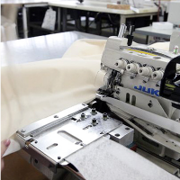 Mattress side panels are carefully fed into a fine stitcher.